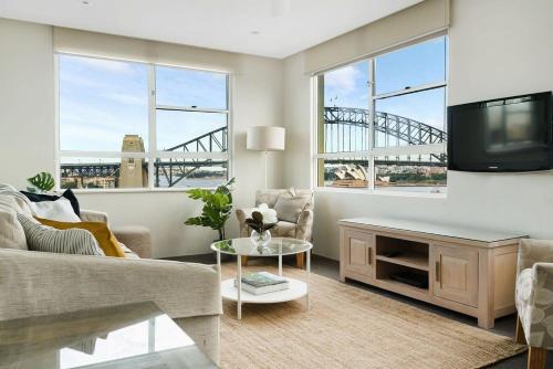 a living room with a couch and a tv at Harbourside #76 in Sydney