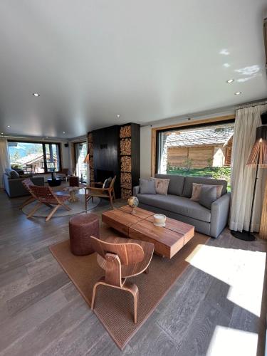 a living room with a couch and a table at MAD Retreat Hotel in Nendaz