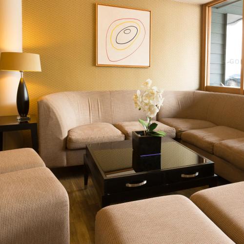 a living room with a couch and a table at Golden Sands in St Brelade