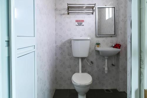 a bathroom with a toilet and a sink at 69 Hotel in Melaka