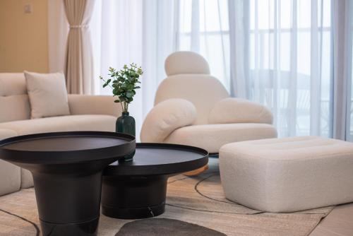 a living room with a black coffee table and a couch at GTC Residence, Luxurious Living in The Heart of Nairobi, Westlands in Nairobi