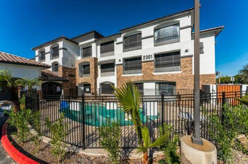 an apartment building with a pool in front of it at Metro Tempe Extended Stay - 2 Full Beds in Tempe