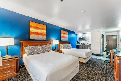 a bedroom with two beds and a blue wall at Metro Extended Stays - Tempe - 2 Full Beds in Tempe