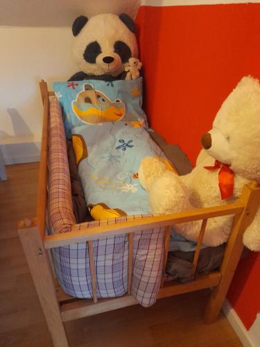 two stuffed animals are sitting on a crib at Holiday apartment & boat rental in Sindal