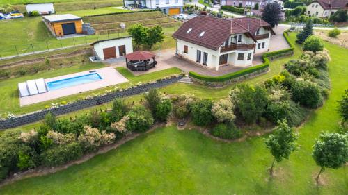 an aerial view of a house with a swimming pool at Luxury 10-bed villa with view pool playground in Horní Planá