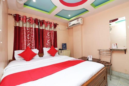 a bedroom with a large bed with red pillows at Xpress Inn in Garui