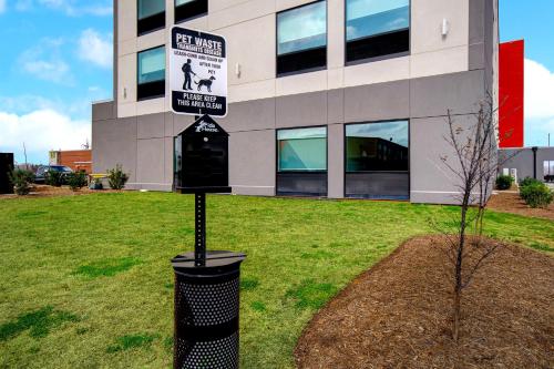 a sign in the grass in front of a building at avid Hotel Fort Mill - Carowinds Blvd by IHG in Fort Mill