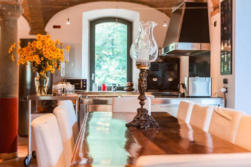 a kitchen with a table with a glass vase on it at Origine Country Farm in Tabiano