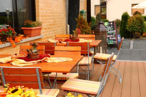 a group of tables and chairs on a patio at Hotel Restaurant Gilles in Kollig