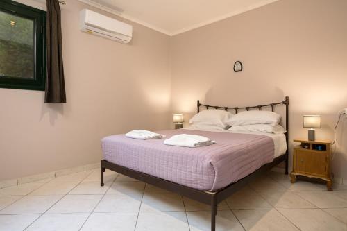 a bedroom with a bed with two towels on it at One Bedroom Villa in Alikanas