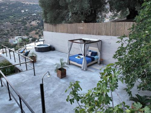a gazebo with a blue couch on a patio at Star Sleep Rodakino in Rethymno Town