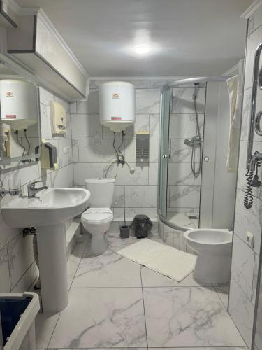 a bathroom with a sink and a toilet and a shower at In hotel in Kamianets-Podilskyi