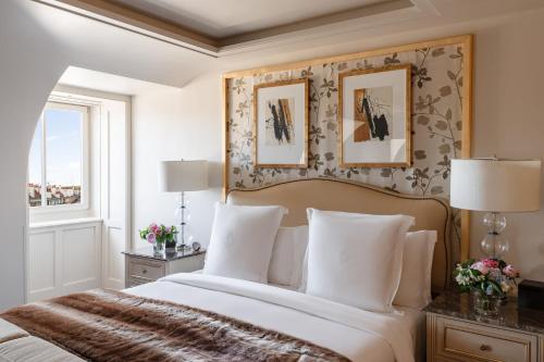 a bedroom with a large bed with white pillows at Four Seasons Hotel des Bergues Geneva in Geneva