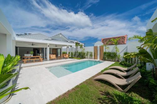 an image of a villa with a swimming pool at Brand New 4BR Balinese Style Pool Villa Kaia just 5 min drive from NaiHarn Beach in Rawai Beach