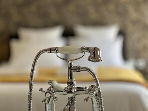 a close up of a metal faucet on a sink at La Suite - Villa Valmy - Hypercentre - Gare SNCF in Montluçon