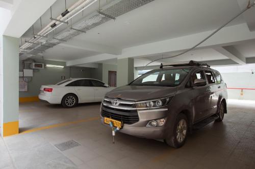 a parking garage with two cars parked in it at 44 Oasis in Chennai