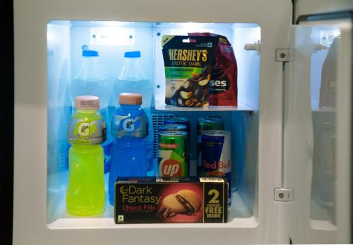 an open refrigerator filled with drinks and snacks at 44 Oasis in Chennai