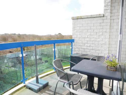 a patio with a table and chairs on a balcony at Badhotel Callantsoog in Callantsoog