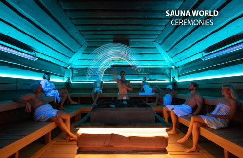 a group of people sitting in a room with a pool at Wellness Hotel Step - Czech Leading Hotels in Prague
