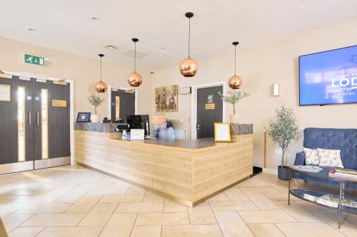 a lobby with a reception counter in a store at The Lodge Hotel in Newbury