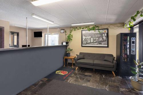 a waiting room with a couch in an office at Super 8 by Wyndham Fort Mitchell Cincinnati Area in Fort Mitchell