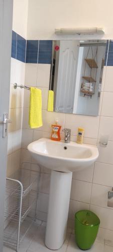 a bathroom with a white sink and a mirror at Racecourse gardens furnished apartments in Nairobi