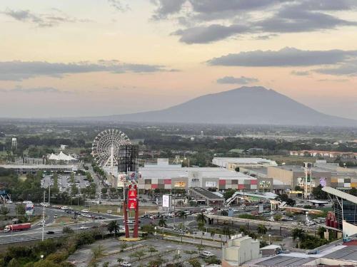 a city with a ferris wheel and a roller coaster at The Comfy Loft in San Fernando