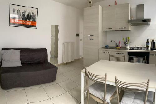 a living room with a table and a kitchen at Lovely apartment in center Seregno in Seregno