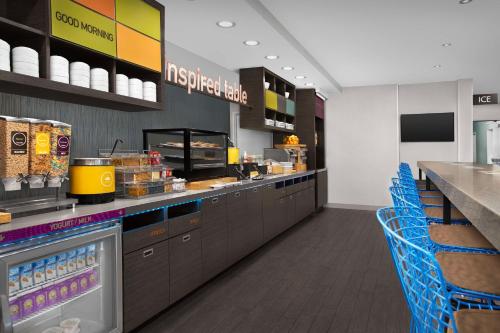 a fast food restaurant with blue chairs and a counter at Home2 Suites by Hilton Pittsburgh - McCandless, PA in McCandless Township