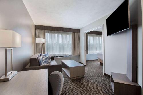 a large hotel room with a living room at Days Inn & Suites by Wyndham Moncton in Moncton