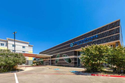 a building with a sign on the side of it at Days Inn & Suites by Wyndham Lubbock Medical Center in Lubbock