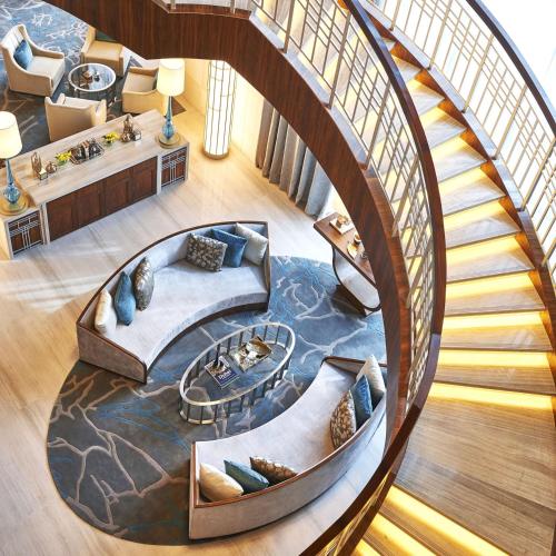 a spiral staircase leading up to a hotel lobby at Hilton Dubai Al Habtoor City in Dubai