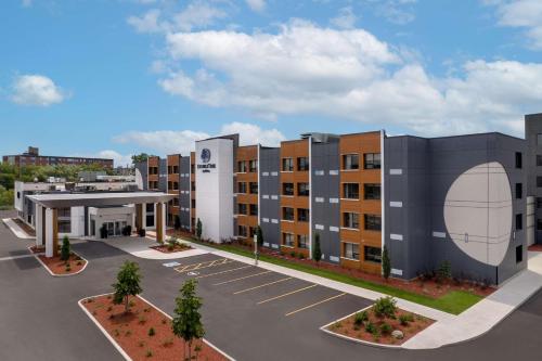 a rendering of an apartment building with a parking lot at DoubleTree by Hilton Kingston - Newly Renovated in Kingston