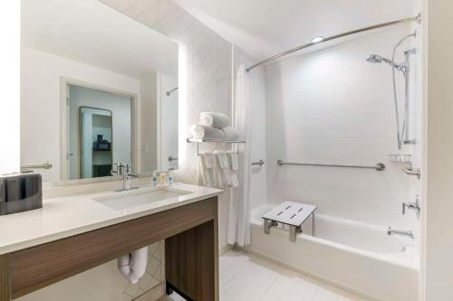 a bathroom with a sink and a tub and a shower at Comfort Suites St Augustine Historic District Area in Saint Augustine