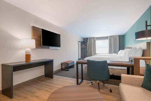 a hotel room with a bed and a desk at Comfort Suites St Augustine Historic District Area in Saint Augustine