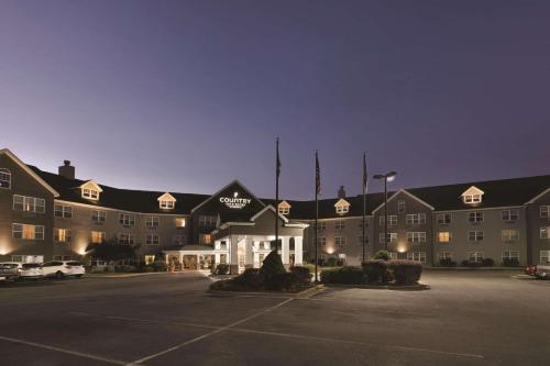 a large building with a parking lot in front of it at Country Inn & Suites by Radisson, Beckley, WV in Beckley
