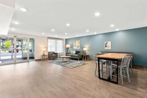 a living room with a table and chairs at WoodSpring Suites Savannah West Chatham Parkway in Savannah