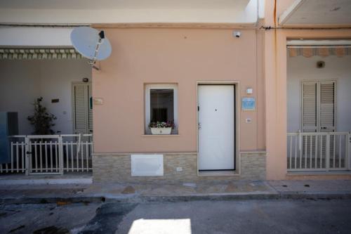 a white door on the side of a building at casa vacanze Diletta in Santa Maria al Bagno