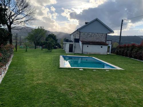 a house with a swimming pool in a yard at Quinta da Capela in Celorico de Basto