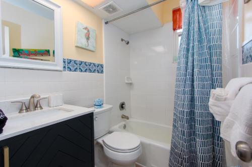 a bathroom with a toilet and a sink and a shower at Clearwater Beach Suites #106 in Clearwater Beach