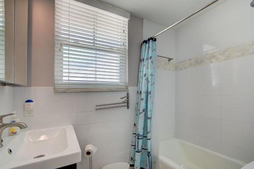 a bathroom with a sink and a shower curtain at Clearwater Beach Suites #104 in Clearwater Beach