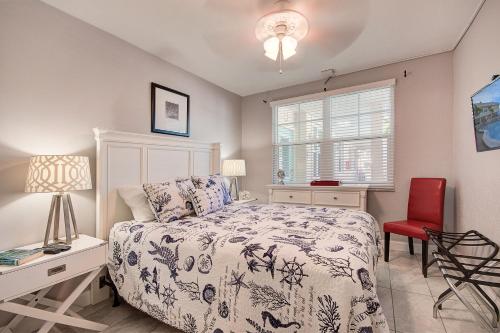 a bedroom with a bed and a red chair at Clearwater Beach Suites #104 in Clearwater Beach