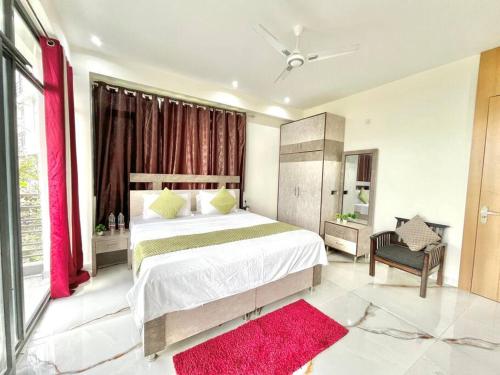 a bedroom with a large bed and a red window at host jatin kasauli crest 7o1827o7o3 in Kasauli