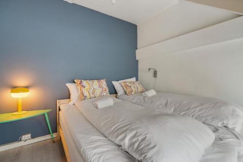 a room with a bed and a table with a lamp at BUDGETEL- Kong Oscarsgate 44 in Bergen