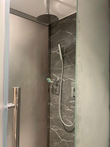 a bathroom with a shower with a glass door at High Village Hotel in Al Namas