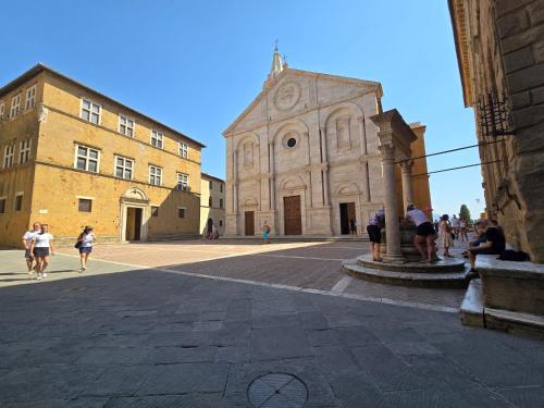 a group of people walking around a building at Finestra Dell'Angelo in Pienza
