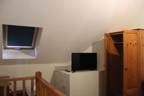 a television on top of a refrigerator in a room at Parkfields Barns Self Catering Accommodation in Buckingham