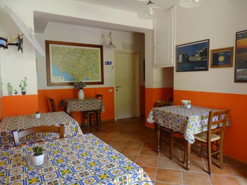 a restaurant with two tables and a map on the wall at Archi Di Sole in Riccò del Golfo di Spezia