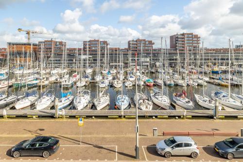 a group of cars parked in a marina with boats at BizStay Harbour I Scheveningen Apartments in Scheveningen