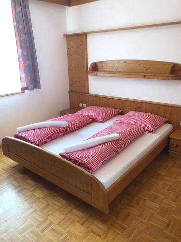 a bed with two pillows on it in a room at Hotel Ledererwirt in Sankt Lambrecht